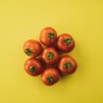 red tomato on yellow surface