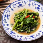 a bowl of broccoli and other vegetables on a table