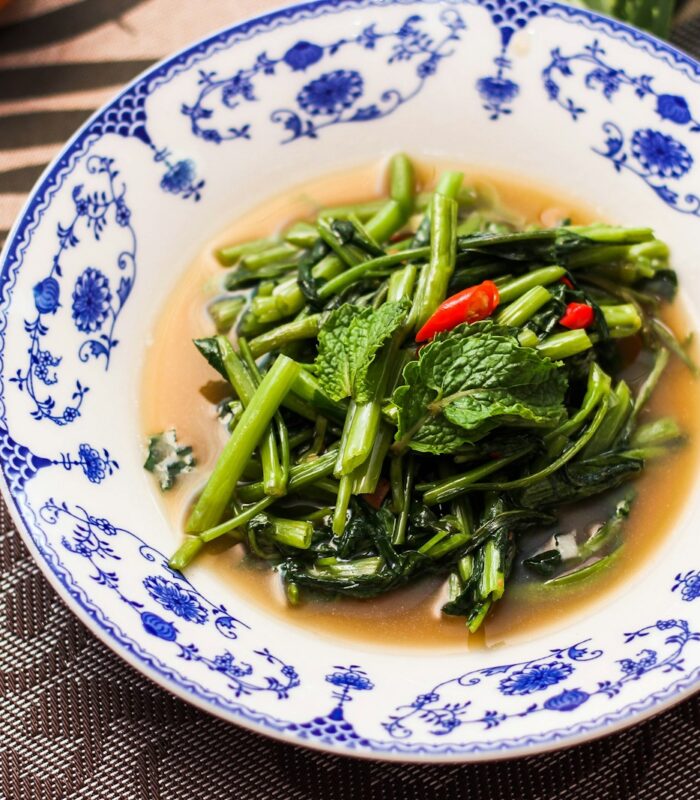 a bowl of broccoli and other vegetables on a table